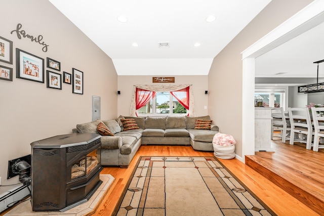 living area with baseboard heating, plenty of natural light, light wood finished floors, and recessed lighting