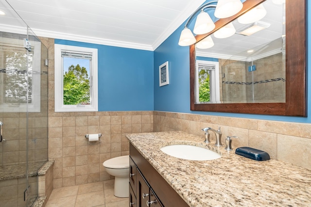 full bathroom with tile walls, crown molding, a stall shower, tile patterned floors, and vanity