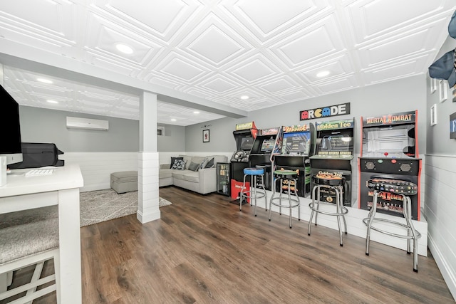 recreation room with a wall mounted air conditioner, wood finished floors, wainscoting, recessed lighting, and an ornate ceiling