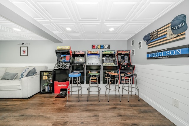 rec room featuring an ornate ceiling, wood finished floors, recessed lighting, and wooden walls