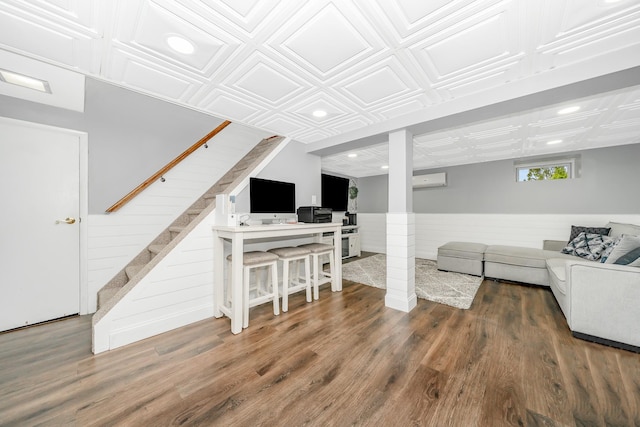 living area featuring recessed lighting, an ornate ceiling, a wainscoted wall, stairs, and wood finished floors