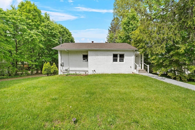 16 S Lawrence Ave, Elmsford, NY 10523 - back of property featuring entry steps, a yard, and brick siding