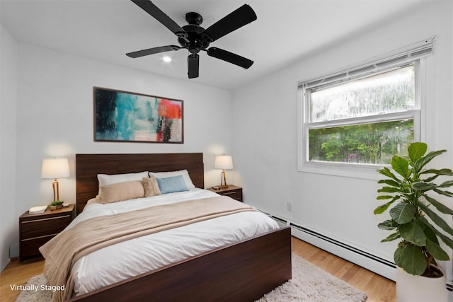 16 S Lawrence Ave, Elmsford, NY 10523 - bedroom with baseboard heating, light wood-type flooring, and ceiling fan