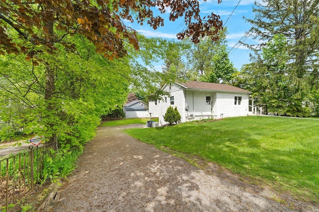16 S Lawrence Ave, Elmsford, NY 10523 - view of front facade with a front yard, driveway, and stucco siding