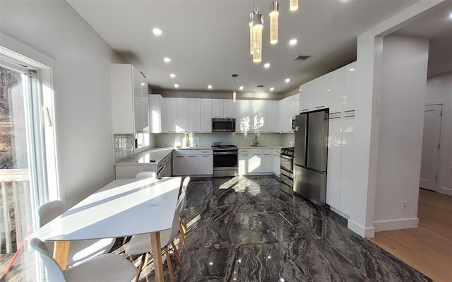 27 Catskill High Rail, Monroe, NY 10950 - kitchen with appliances with stainless steel finishes, decorative light fixtures, light countertops, white cabinetry, and recessed lighting