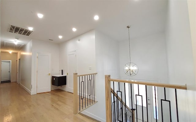 27 Catskill High Rail, Monroe, NY 10950 - hallway featuring light wood finished floors, an upstairs landing, a chandelier, recessed lighting, and baseboards