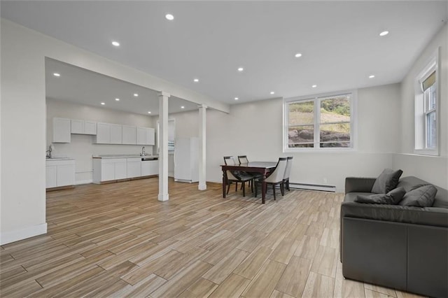 27 Catskill High Rail, Monroe, NY 10950 - living room featuring a baseboard radiator, ornate columns, light wood finished floors, and recessed lighting