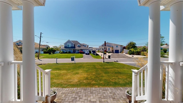 39 Whiting Rd, East Quogue, NY 11942 - view of grassy yard with covered porch and a residential view