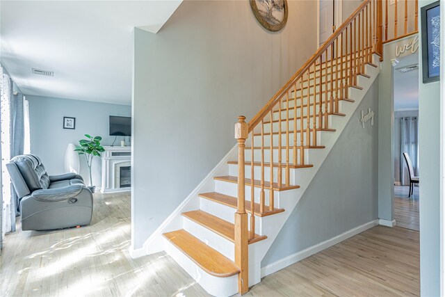 7 Angelas Way, Goshen, NY 10924 - stairs with wood finished floors, baseboards, and a fireplace