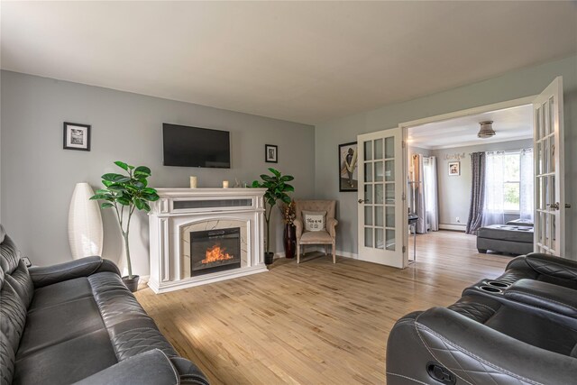 7 Angelas Way, Goshen, NY 10924 - living area featuring french doors, wood finished floors, a fireplace, and baseboards