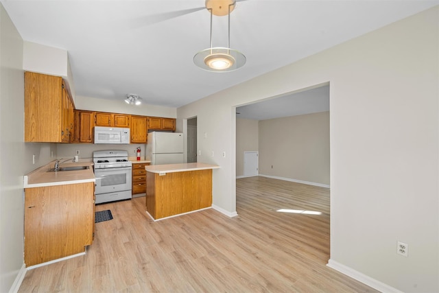 65 Jimal Dr, Middletown, NY 10940 - kitchen featuring white appliances, a sink, brown cabinets, and light countertops