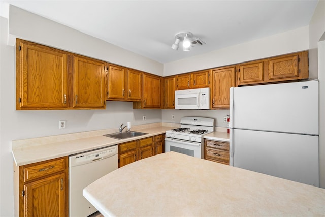 65 Jimal Dr, Middletown, NY 10940 - kitchen with white appliances, a sink, brown cabinets, and light countertops