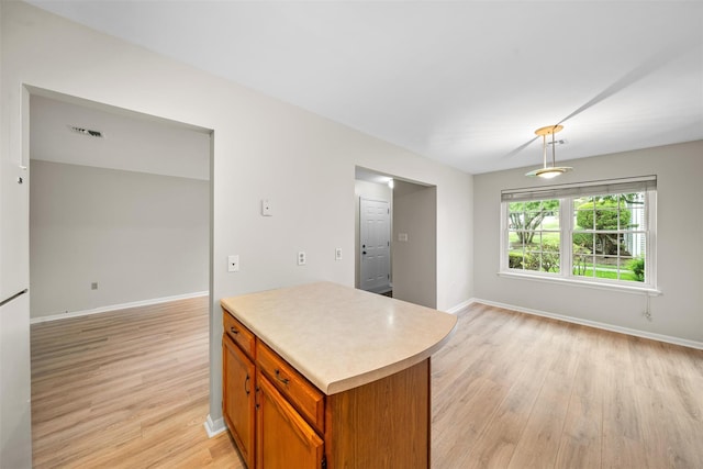 65 Jimal Dr, Middletown, NY 10940 - kitchen featuring light wood-type flooring, light countertops, baseboards, and brown cabinets