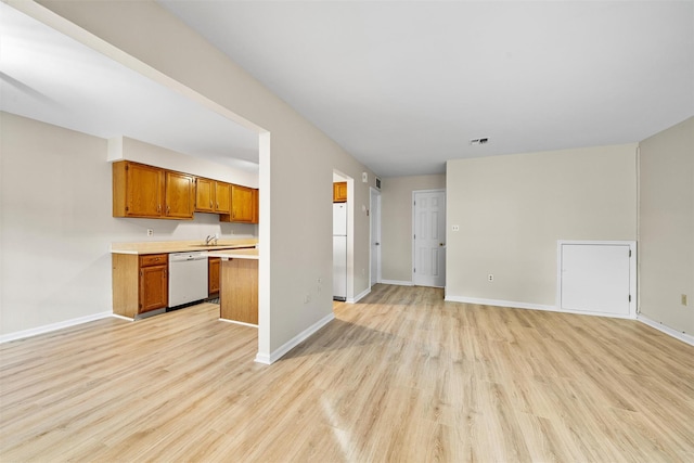 65 Jimal Dr, Middletown, NY 10940 - kitchen featuring white appliances, open floor plan, a sink, light wood-style floors, and light countertops