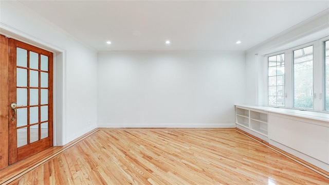 spare room featuring wood finished floors, baseboards, and recessed lighting