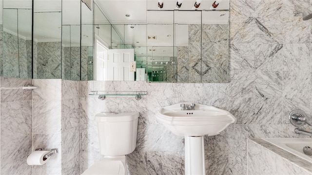 full bath featuring toilet and tile walls