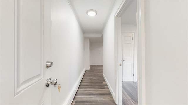 hall featuring crown molding, wood finished floors, and baseboards