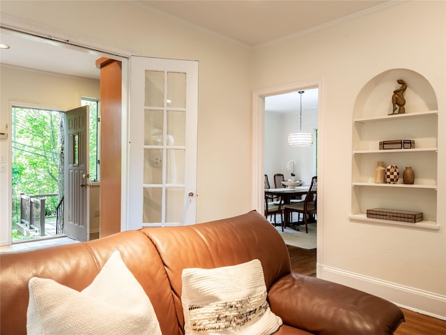 37 Longview Rd, Port Washington, NY 11050 - living area featuring ornamental molding, wood finished floors, built in shelves, and baseboards