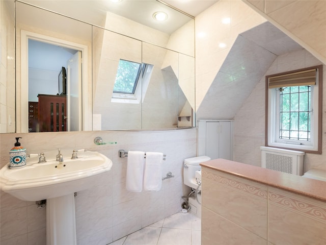 37 Longview Rd, Port Washington, NY 11050 - bathroom with radiator, tile walls, a skylight, toilet, and tile patterned floors