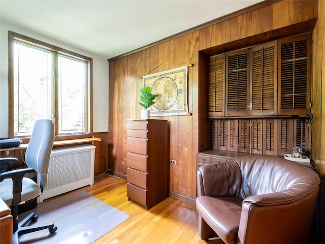 37 Longview Rd, Port Washington, NY 11050 - home office featuring radiator heating unit, light wood-type flooring, and wooden walls