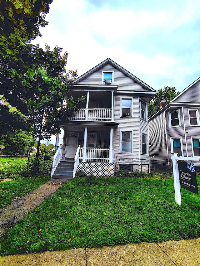 view of front of house featuring a balcony and covered porch