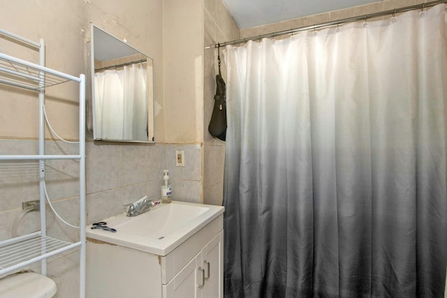bathroom with vanity, tile walls, toilet, and a shower with shower curtain