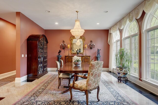 dining area featuring baseboards, recessed lighting, and a chandelier