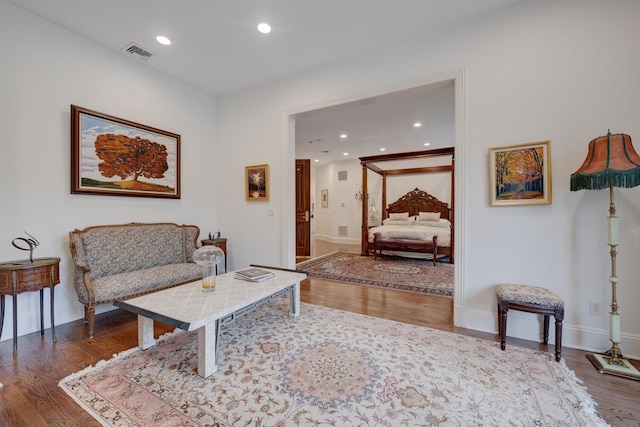 living room featuring wood finished floors, baseboards, and recessed lighting