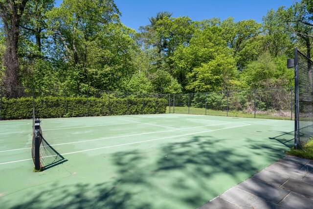view of tennis court with fence