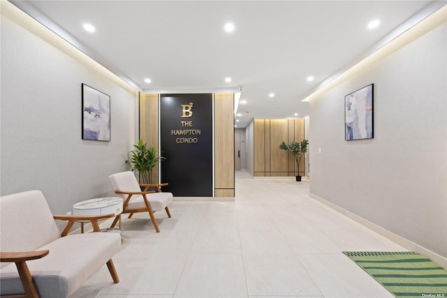 hallway with recessed lighting, light tile patterned floors, and baseboards