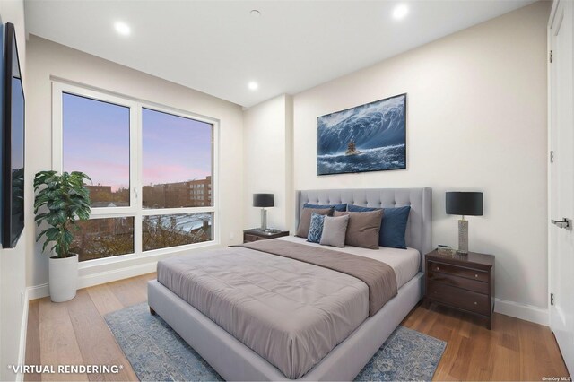 bedroom featuring wood finished floors, baseboards, and recessed lighting