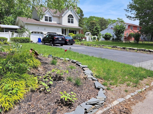 85 Mowbray St, Patchogue, NY 11772 - view of yard featuring asphalt driveway and an attached garage