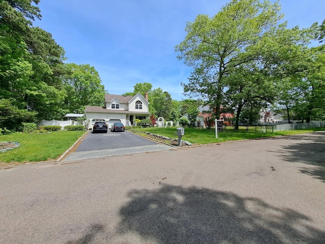 85 Mowbray St, Patchogue, NY 11772 - view of property with driveway, a chimney, and a garage