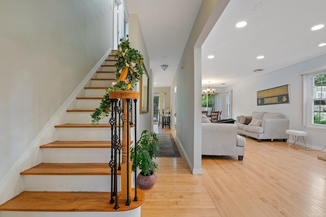 85 Mowbray St, Patchogue, NY 11772 - stairs featuring wood finished floors, recessed lighting, and a chandelier
