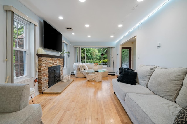 85 Mowbray St, Patchogue, NY 11772 - living room featuring a fireplace, light wood-style floors, and recessed lighting