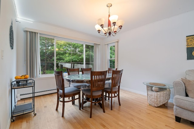 85 Mowbray St, Patchogue, NY 11772 - dining room with a baseboard radiator, light wood-style flooring, and a chandelier