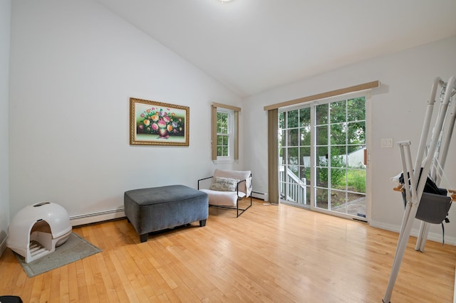 85 Mowbray St, Patchogue, NY 11772 - sitting room with a baseboard radiator, hardwood / wood-style floors, and vaulted ceiling
