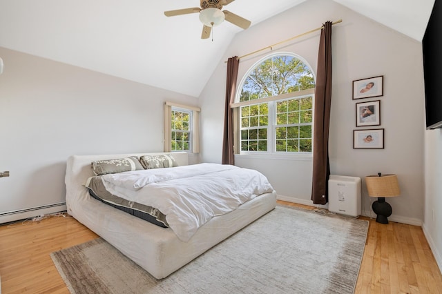 85 Mowbray St, Patchogue, NY 11772 - bedroom featuring wood finished floors, vaulted ceiling, a baseboard radiator, and ceiling fan
