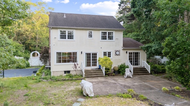 85 Mowbray St, Patchogue, NY 11772 - back of property featuring a gate, a patio area, and a shingled roof