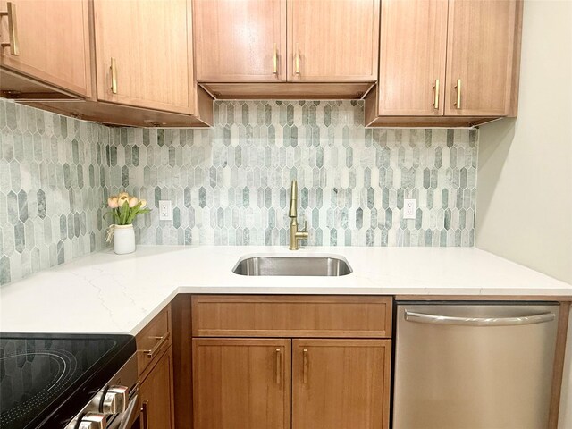 kitchen with dishwasher, a sink, and backsplash