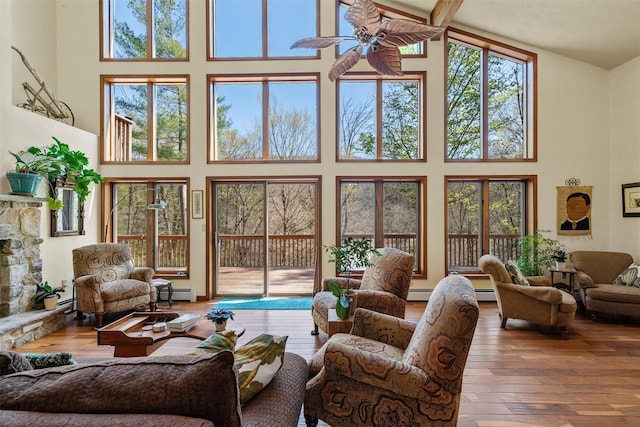 216 Cortese Rd, Call Listing Agent, PA 18405 - living room with a high ceiling, a baseboard radiator, a ceiling fan, and hardwood / wood-style floors