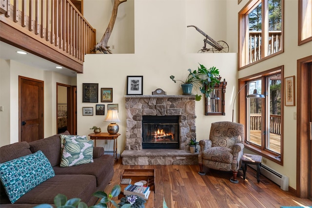 216 Cortese Rd, Call Listing Agent, PA 18405 - living area featuring a high ceiling, a stone fireplace, wood finished floors, and healthy amount of natural light