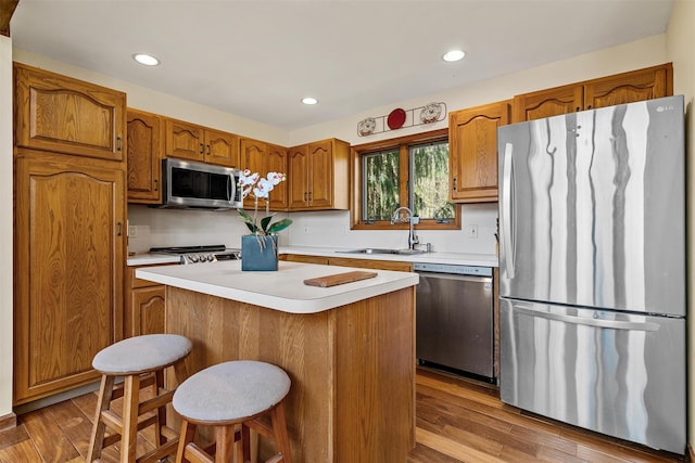 216 Cortese Rd, Call Listing Agent, PA 18405 - kitchen featuring stainless steel appliances, a sink, brown cabinets, light countertops, and recessed lighting