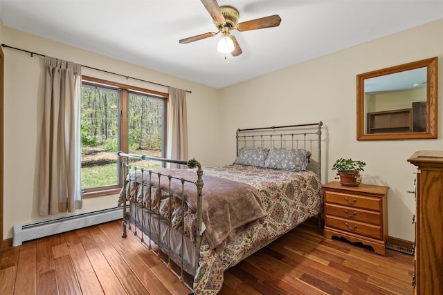 216 Cortese Rd, Call Listing Agent, PA 18405 - bedroom featuring baseboard heating, wood finished floors, and a ceiling fan