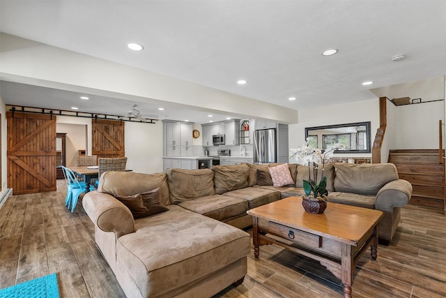 216 Cortese Rd, Call Listing Agent, PA 18405 - living room featuring a barn door, stairs, wood finished floors, and recessed lighting