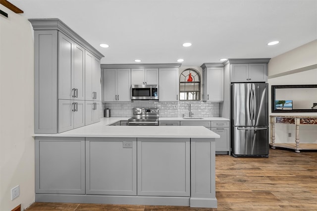 216 Cortese Rd, Call Listing Agent, PA 18405 - kitchen with appliances with stainless steel finishes, gray cabinets, a peninsula, wood finished floors, and recessed lighting