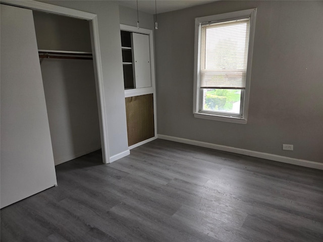163 Villa Ave, Yonkers, NY 10704 - unfurnished bedroom featuring wood finished floors, baseboards, and a closet