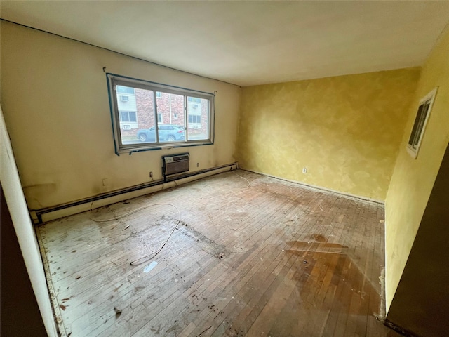 spare room with hardwood / wood-style floors and a baseboard radiator