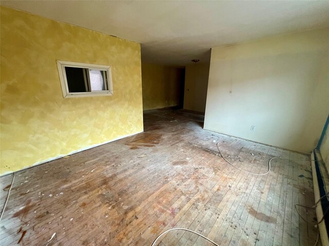 spare room featuring wood-type flooring