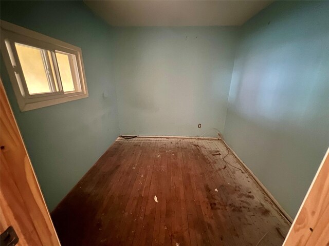 unfurnished room with hardwood / wood-style floors